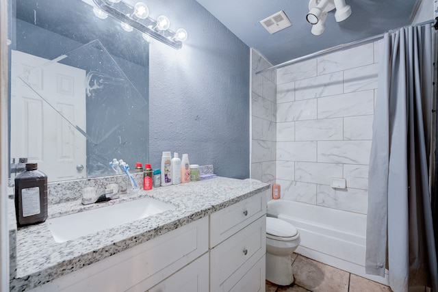 full bathroom featuring vanity, shower / bath combo with shower curtain, toilet, and tile patterned flooring