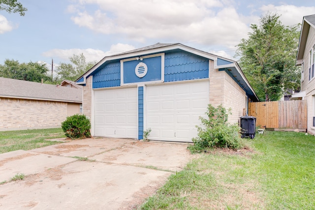 garage featuring a lawn