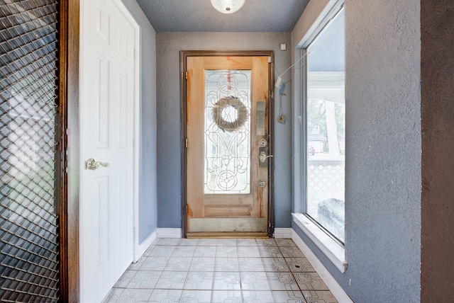 foyer with a textured ceiling