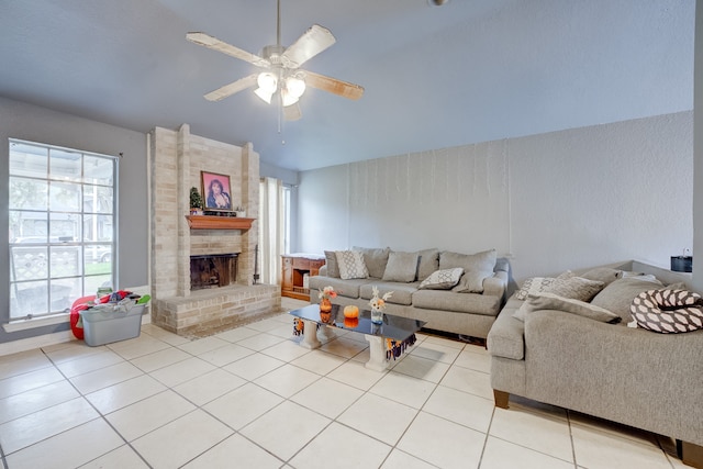 tiled living room with ceiling fan and a fireplace