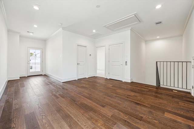 spare room with ornamental molding, dark wood-style floors, attic access, recessed lighting, and baseboards