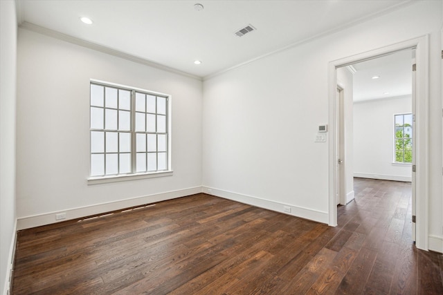 spare room featuring dark wood-style floors, crown molding, baseboards, attic access, and recessed lighting