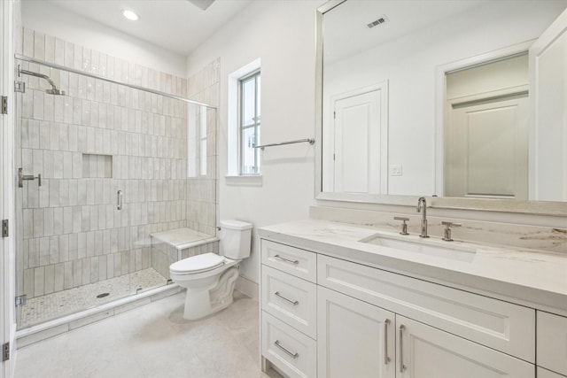 bathroom with a shower stall, toilet, vanity, tile patterned flooring, and recessed lighting