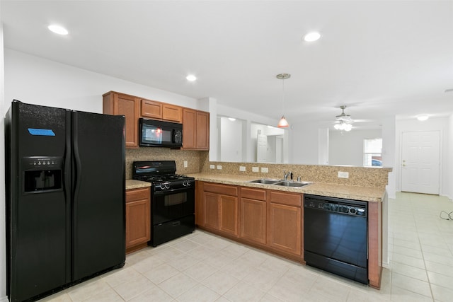 kitchen featuring black appliances, kitchen peninsula, sink, and ceiling fan