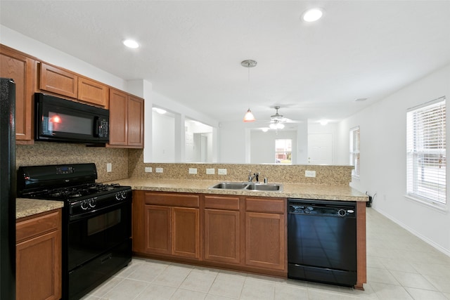 kitchen with sink, kitchen peninsula, decorative backsplash, black appliances, and ceiling fan