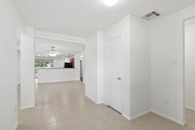 corridor with light tile patterned floors