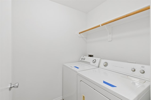 clothes washing area featuring washing machine and clothes dryer