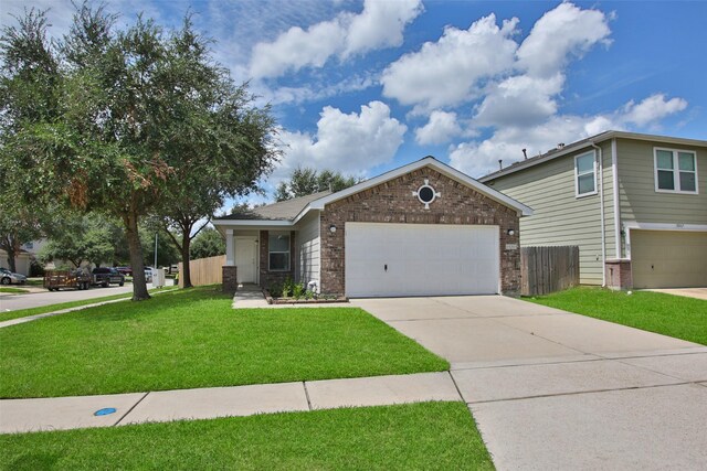 view of front of property featuring a garage and a front lawn