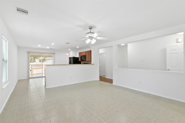 unfurnished living room featuring light tile patterned flooring and ceiling fan