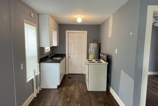 kitchen with white range oven, white cabinetry, water heater, dark hardwood / wood-style flooring, and sink