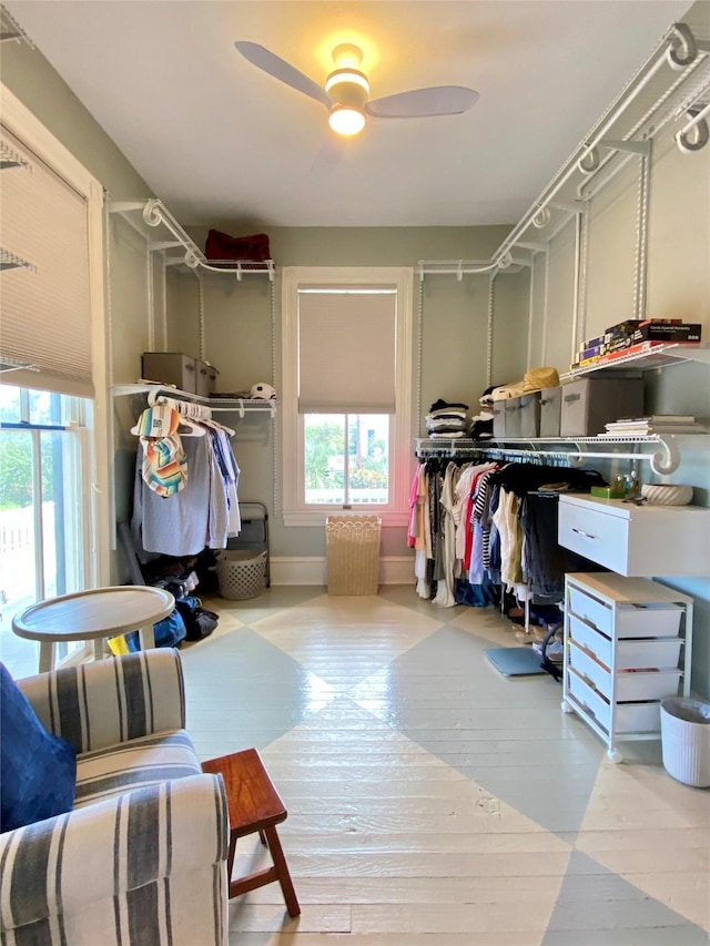 spacious closet with a ceiling fan