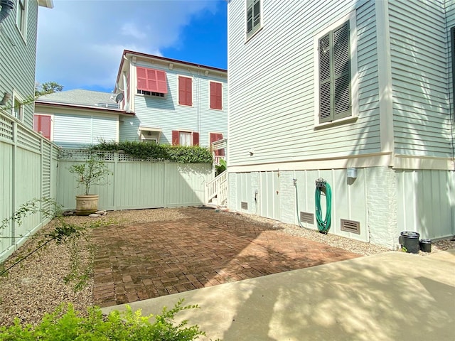 back of house featuring a patio and fence