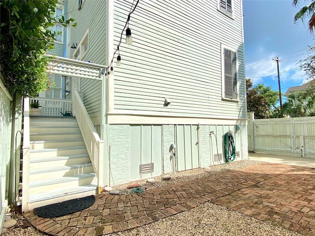 view of home's exterior featuring a patio and fence
