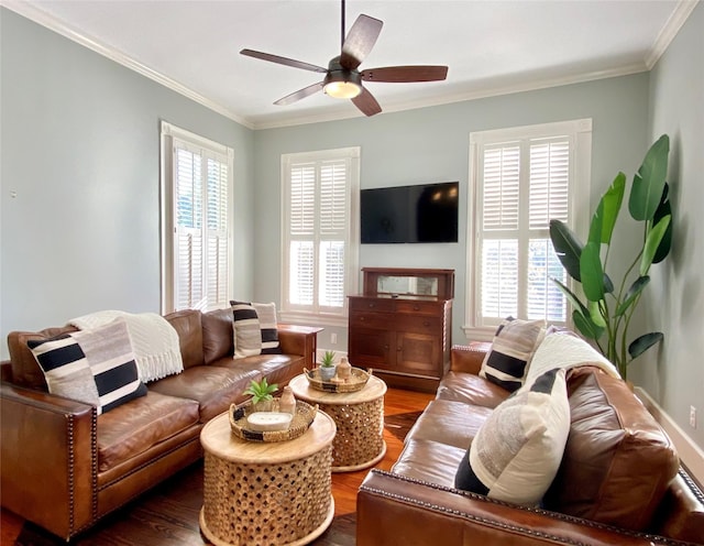 living area featuring dark wood-type flooring, ornamental molding, and ceiling fan
