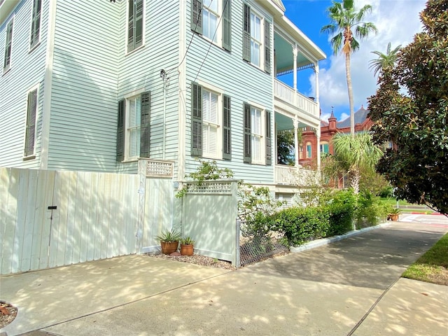 view of side of home with fence
