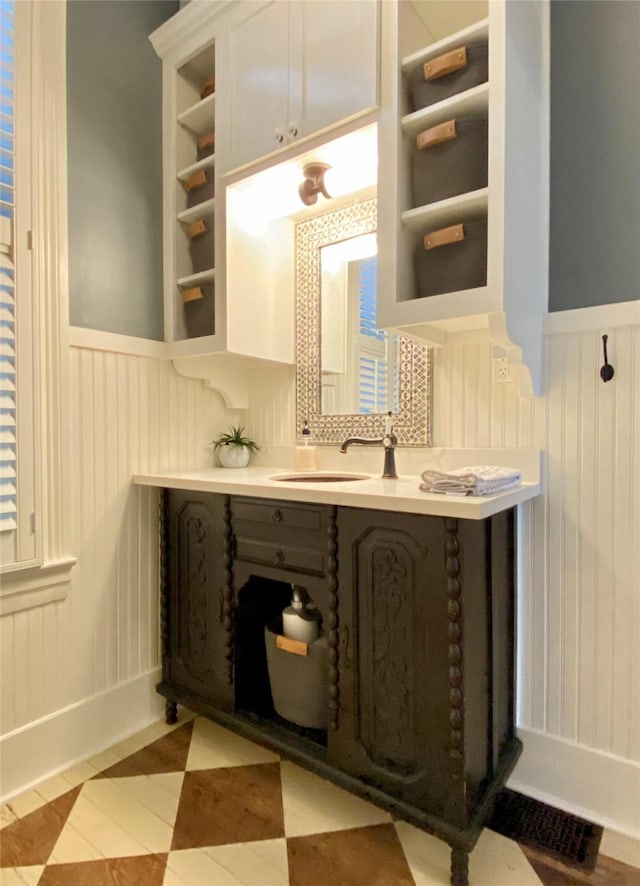 bathroom with vanity and wainscoting