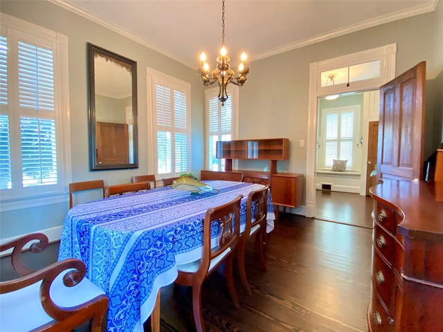 dining space featuring dark wood-type flooring, baseboards, an inviting chandelier, and ornamental molding
