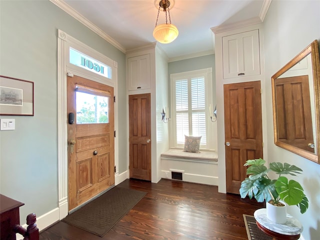 entryway with ornamental molding and dark wood-type flooring