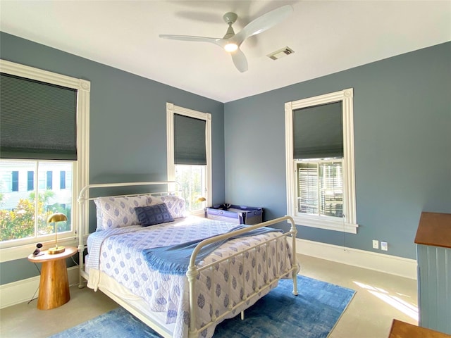 bedroom with visible vents, baseboards, and ceiling fan