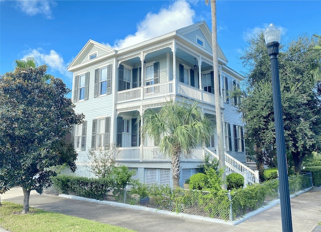 view of home's exterior featuring stairs and a balcony