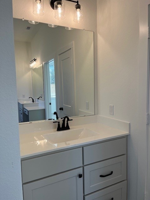 bathroom with visible vents and vanity