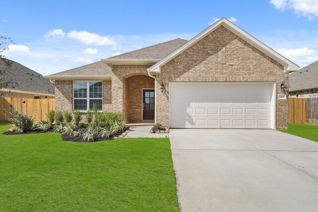 view of front of house featuring a front yard and a garage