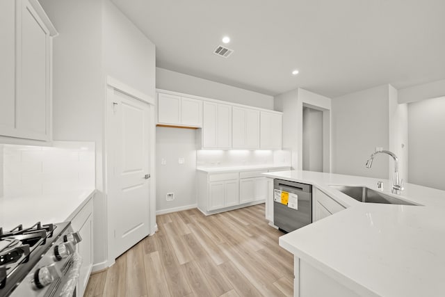 kitchen with stainless steel appliances, sink, light wood-type flooring, and white cabinets