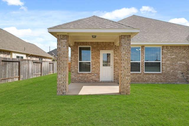 rear view of property with a patio and a yard