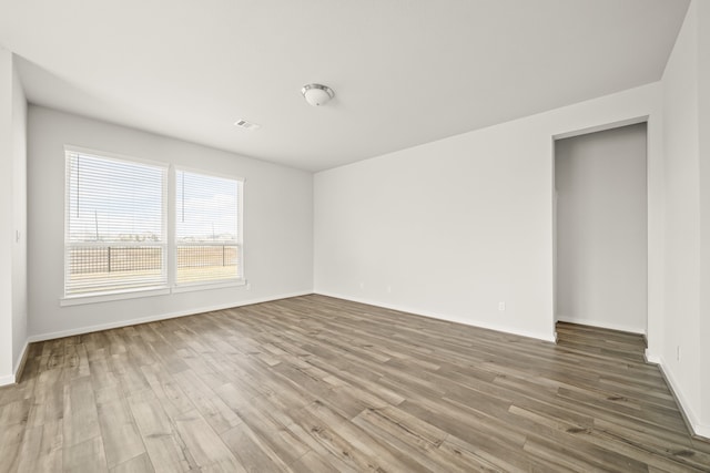 unfurnished room featuring hardwood / wood-style flooring