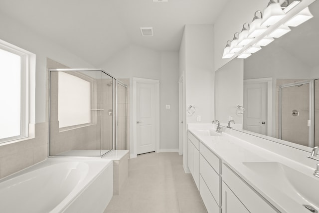 bathroom featuring vanity, lofted ceiling, shower with separate bathtub, and tile patterned floors