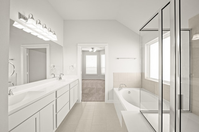 bathroom featuring shower with separate bathtub, ceiling fan, lofted ceiling, vanity, and tile patterned flooring