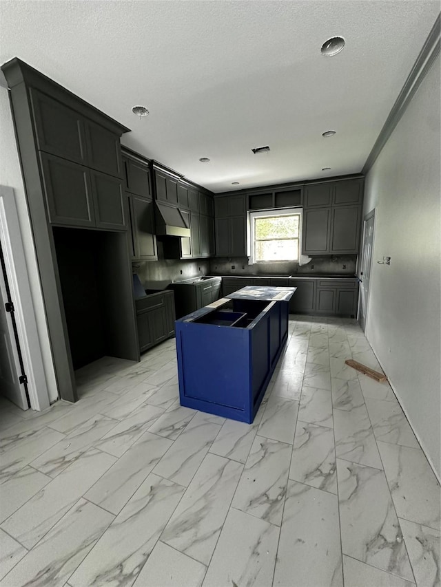 5526 Maywood Dr, Houston, TX 77053 - kitchen with marble finish floor, a kitchen island, range hood, and a textured ceiling