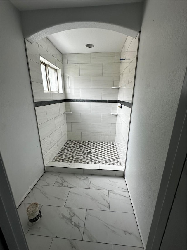 5526 Maywood Dr, Houston, TX 77053 - full bathroom featuring marble finish floor, tiled shower, and a textured wall