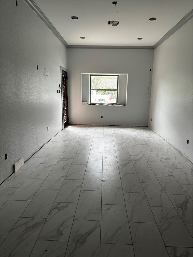 empty room featuring ornamental molding