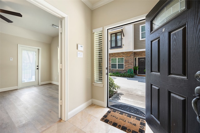 entryway featuring ceiling fan, light hardwood / wood-style flooring, and ornamental molding