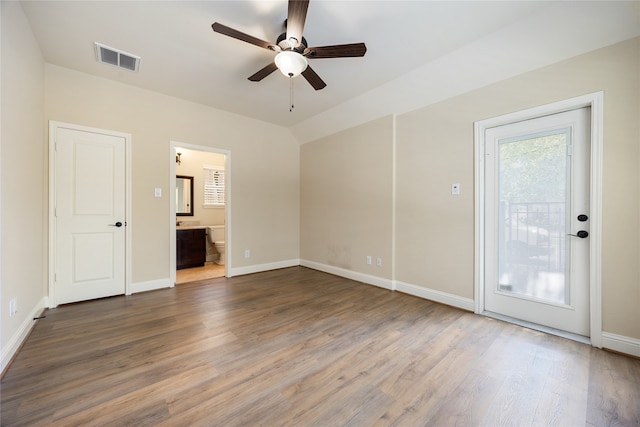 interior space with hardwood / wood-style floors, ceiling fan, ensuite bathroom, and access to exterior