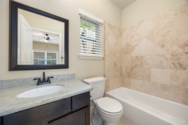 full bathroom featuring ceiling fan, tiled shower / bath, vanity, and toilet