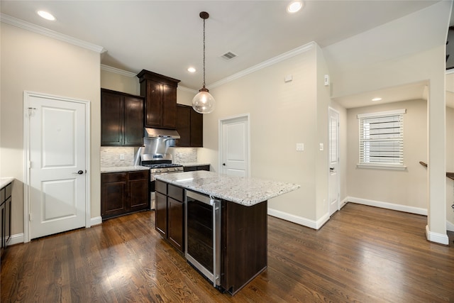 kitchen with pendant lighting, a center island, beverage cooler, gas stove, and dark hardwood / wood-style floors