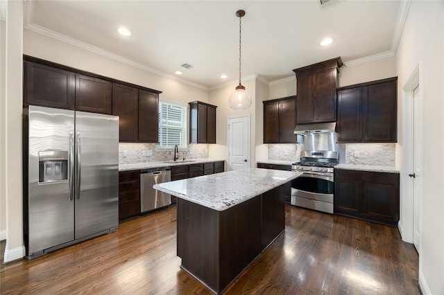 kitchen with a kitchen island, dark hardwood / wood-style flooring, stainless steel appliances, decorative light fixtures, and sink