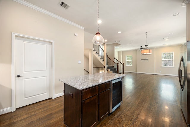 kitchen with pendant lighting, stainless steel fridge, dark brown cabinets, beverage cooler, and dark hardwood / wood-style floors