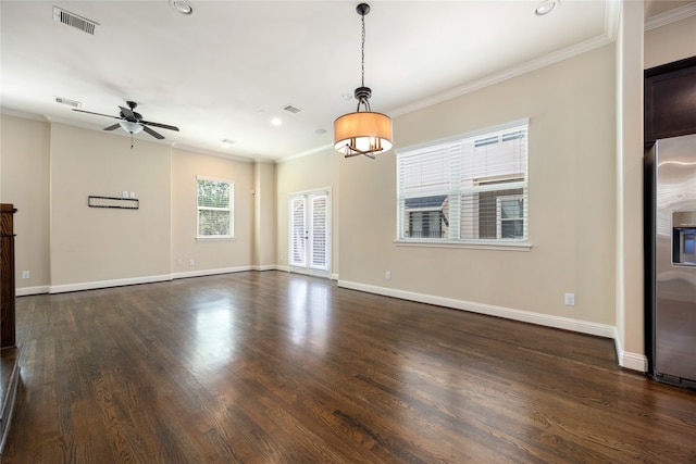 unfurnished living room featuring ceiling fan with notable chandelier, dark hardwood / wood-style floors, and ornamental molding