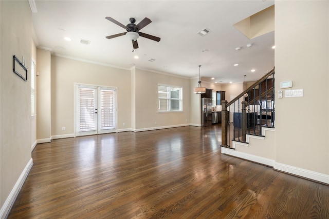 unfurnished living room featuring ceiling fan, dark hardwood / wood-style floors, ornamental molding, and a wealth of natural light