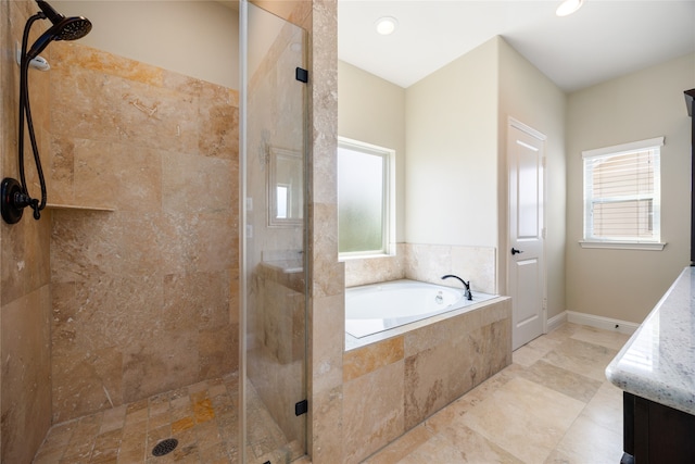 bathroom with plus walk in shower and a healthy amount of sunlight