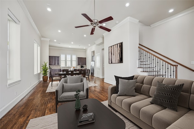 living room with ornamental molding, dark hardwood / wood-style floors, and ceiling fan