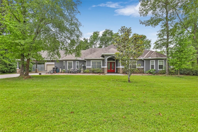 ranch-style house with a front yard and a garage