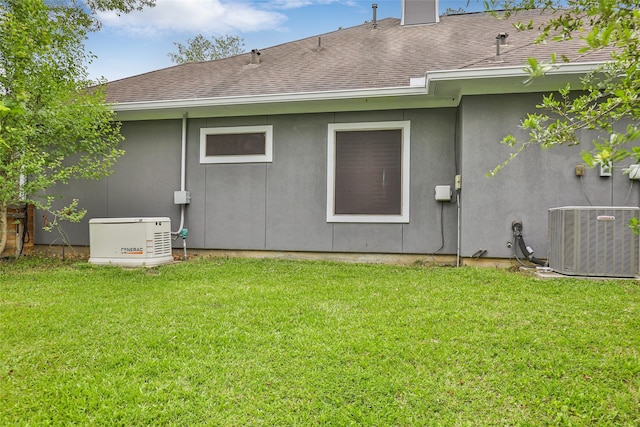 back of property with cooling unit and a lawn