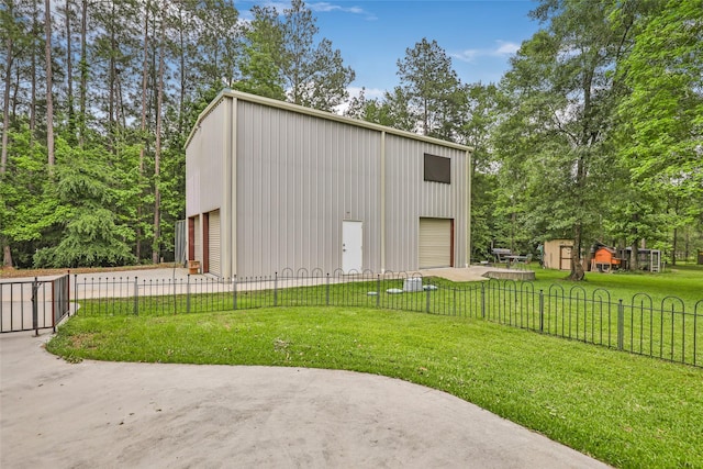 view of outbuilding featuring a lawn and a garage