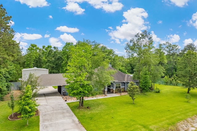 surrounding community featuring a yard and a carport