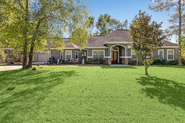 view of front of property with a front yard and a garage