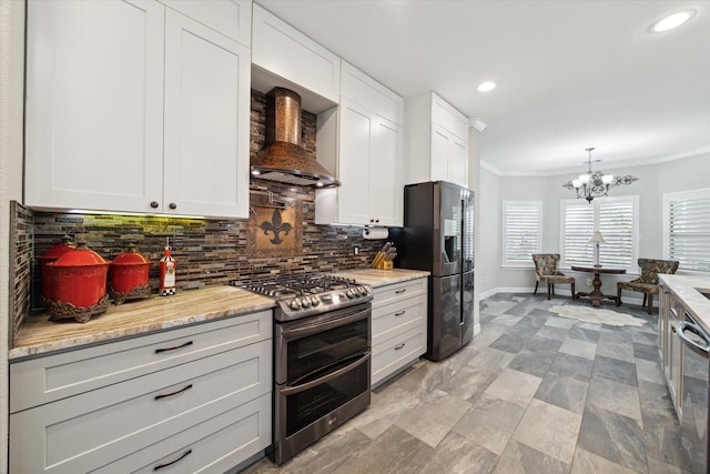 kitchen with white cabinets, light stone countertops, stainless steel appliances, and custom range hood